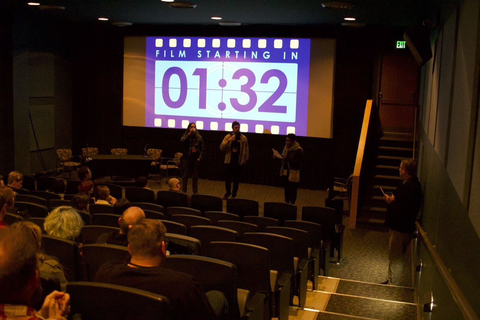 Festival-goers await the start of a film.