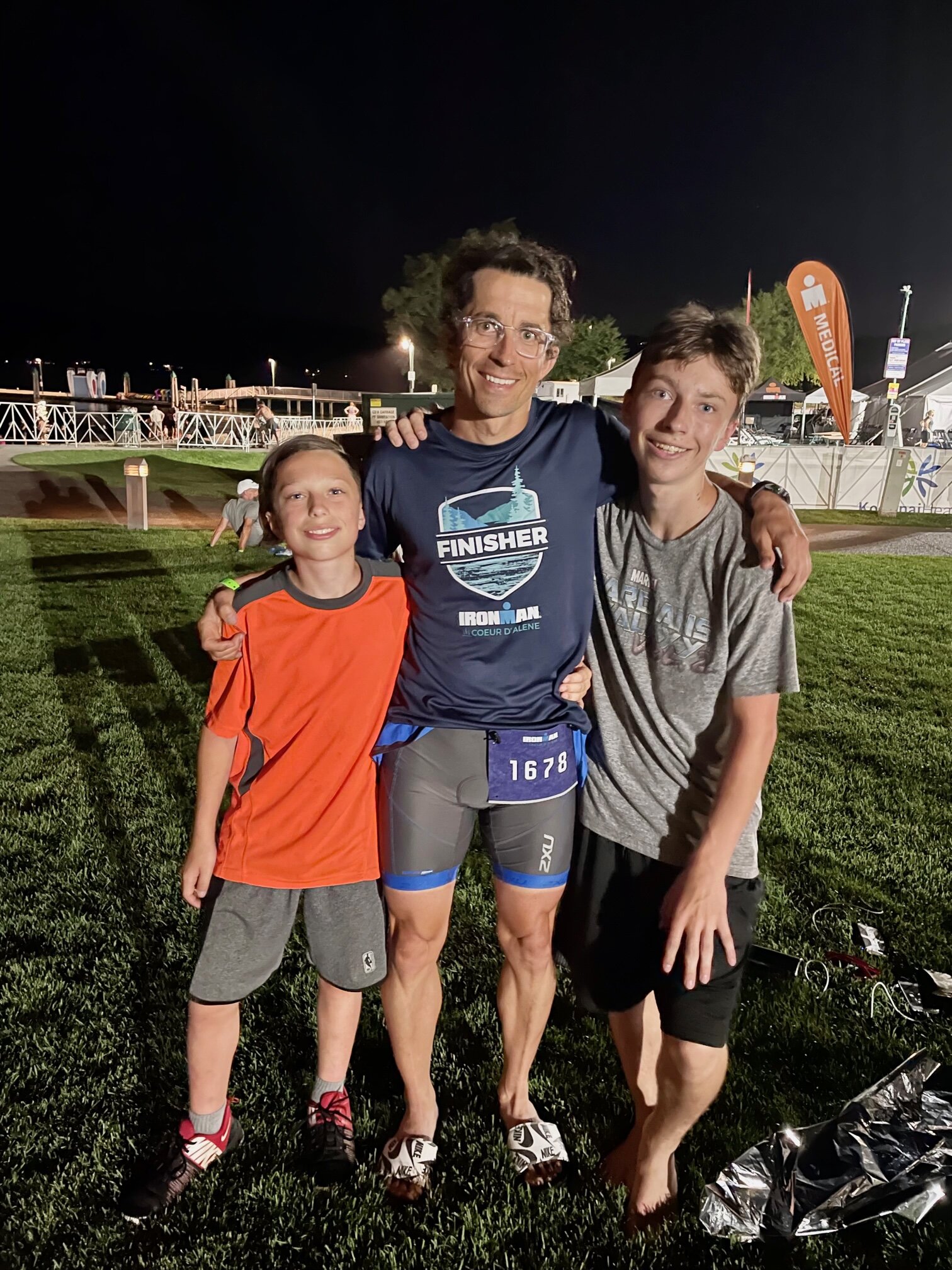 Adam Stakeman at the finish line of Ironman Coeur d’Alene 2021 with his sons.