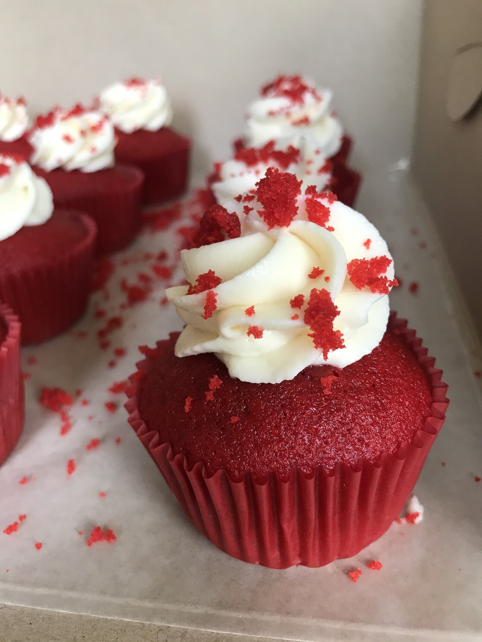 A red velvet cupcake, made by Puff's Pastries.