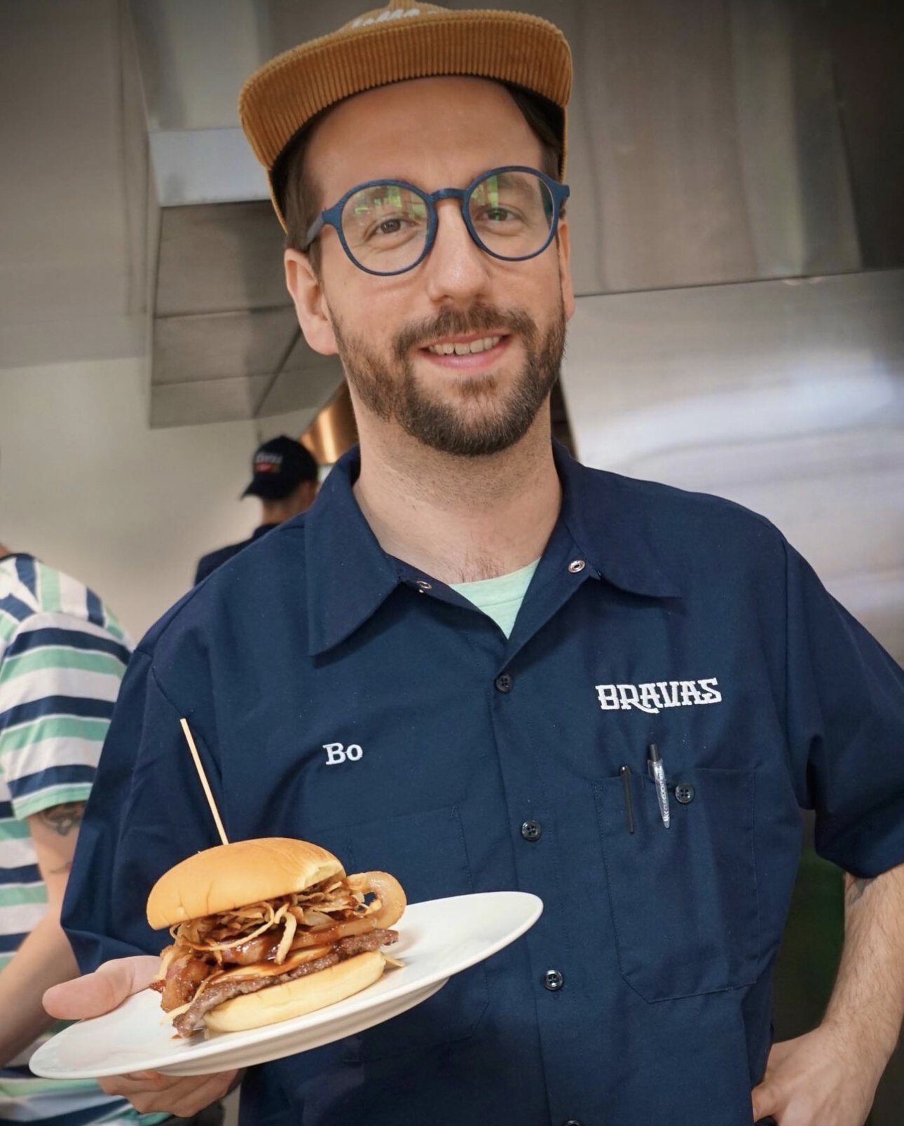 Bo Gonzalaz, owner of Bravas, serving a Dave's Not Here, Man Burger at the new restaurant on Fairfield Avenue.