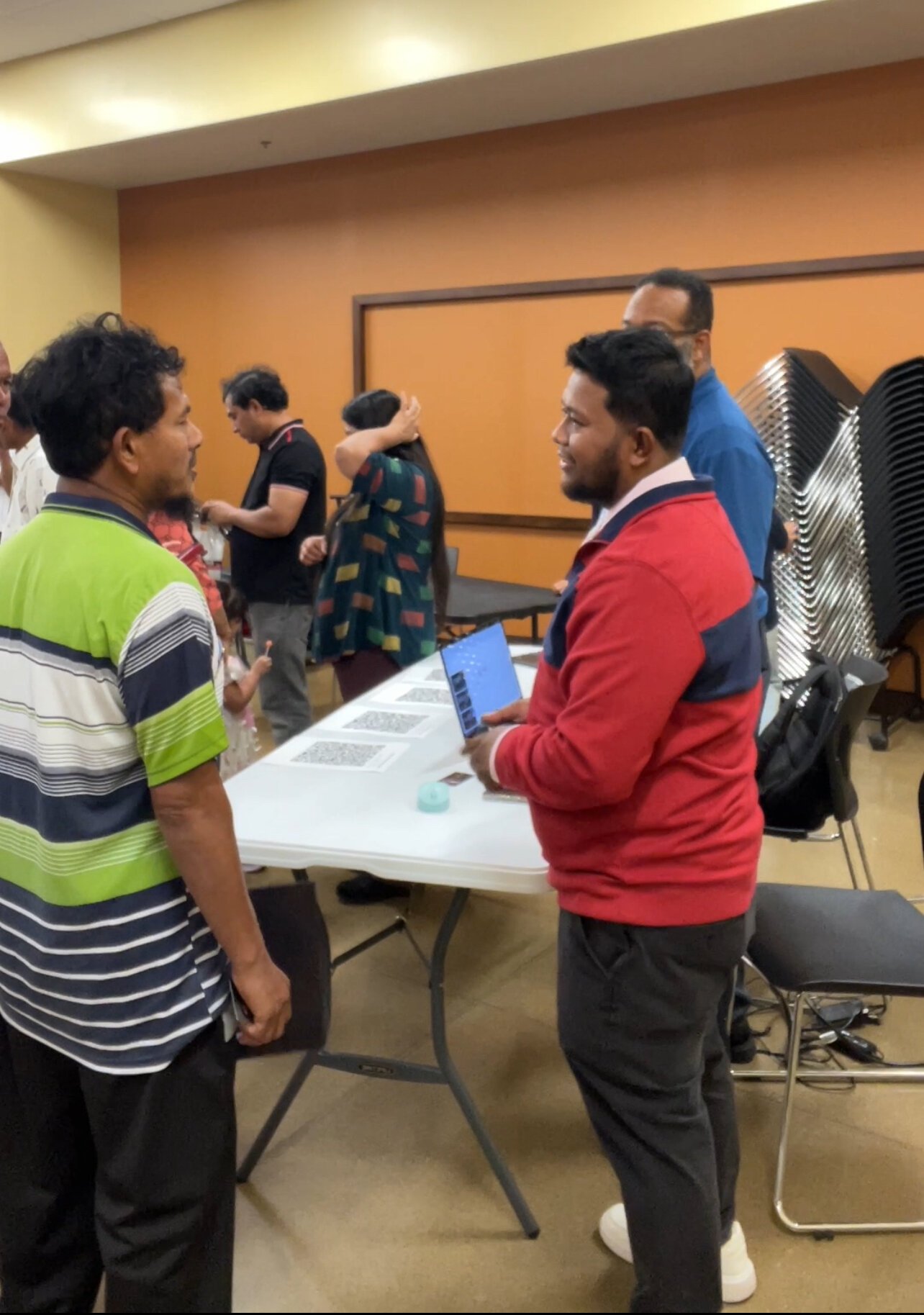 Might Might speaks with attendees at a recent job fair.
