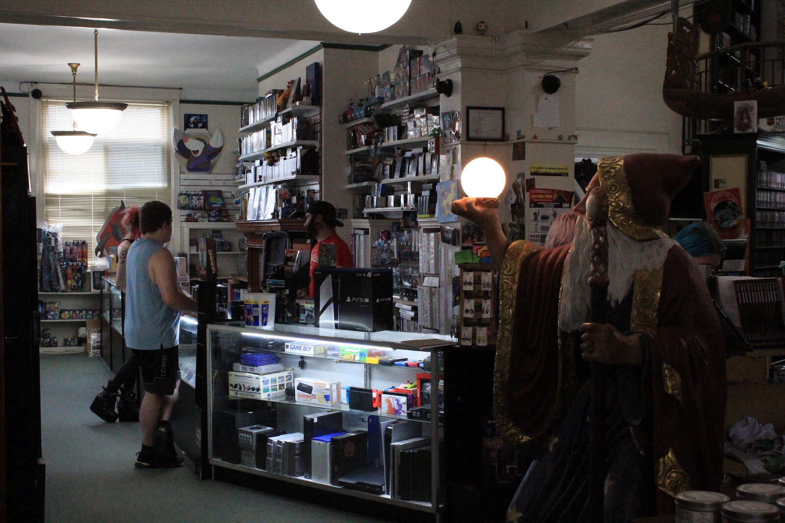 Customers browse a selection of cards at TCB Games.