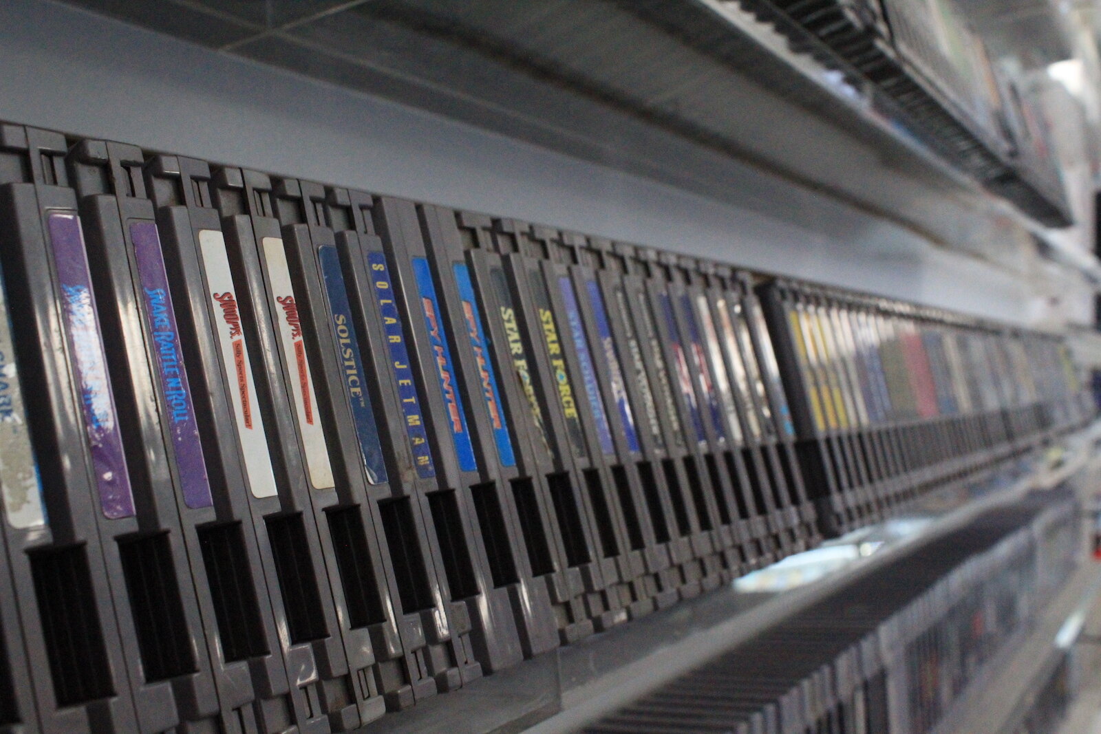 NES game cartridges line the wall at TCB Games.