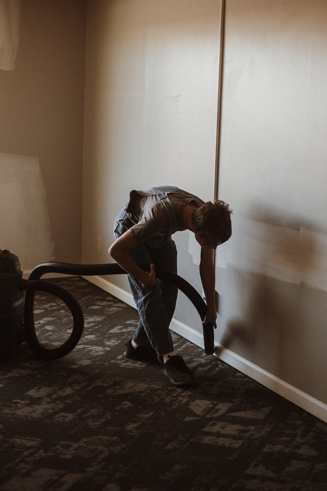 As part of a week-long Pre-Employment Transition Services project, students vacuum at the YWCA's new facility.