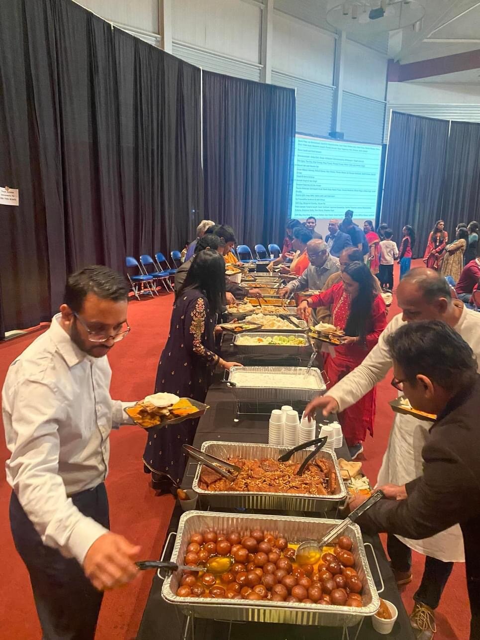 People make their way through the food line.