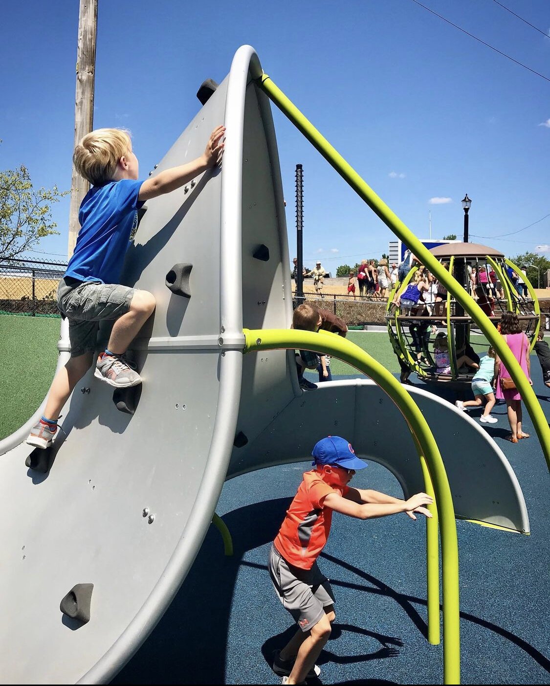 Children climb up playground equipment at the PNC Playground Riverfront Fort Wayne’s Promenade Park.