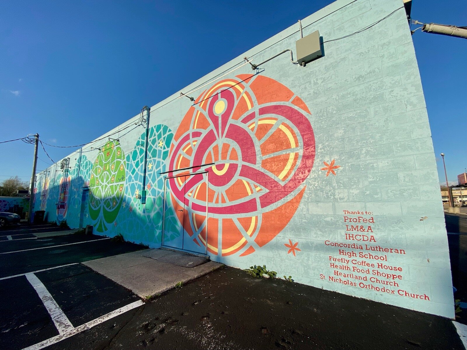 Murals on the side of Firefly Coffee and the Health Food Shoppe in the 3500 block of N. Anthony Blvd.