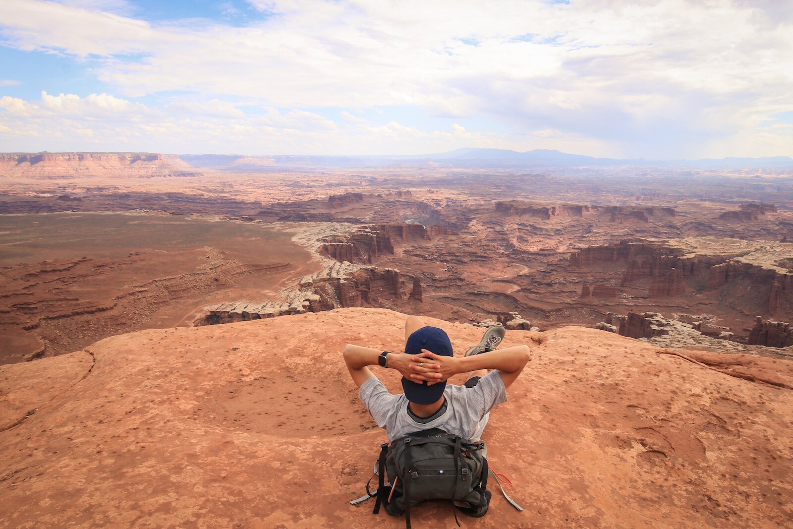 Full-time traveler Erica Esslinger relaxes mid-hike at Canyonlands National Park in Utah.