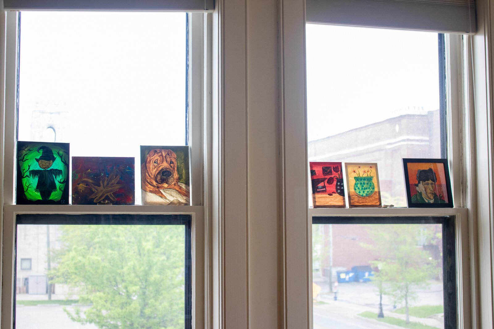 Art lining the windows at Indigo Studio.