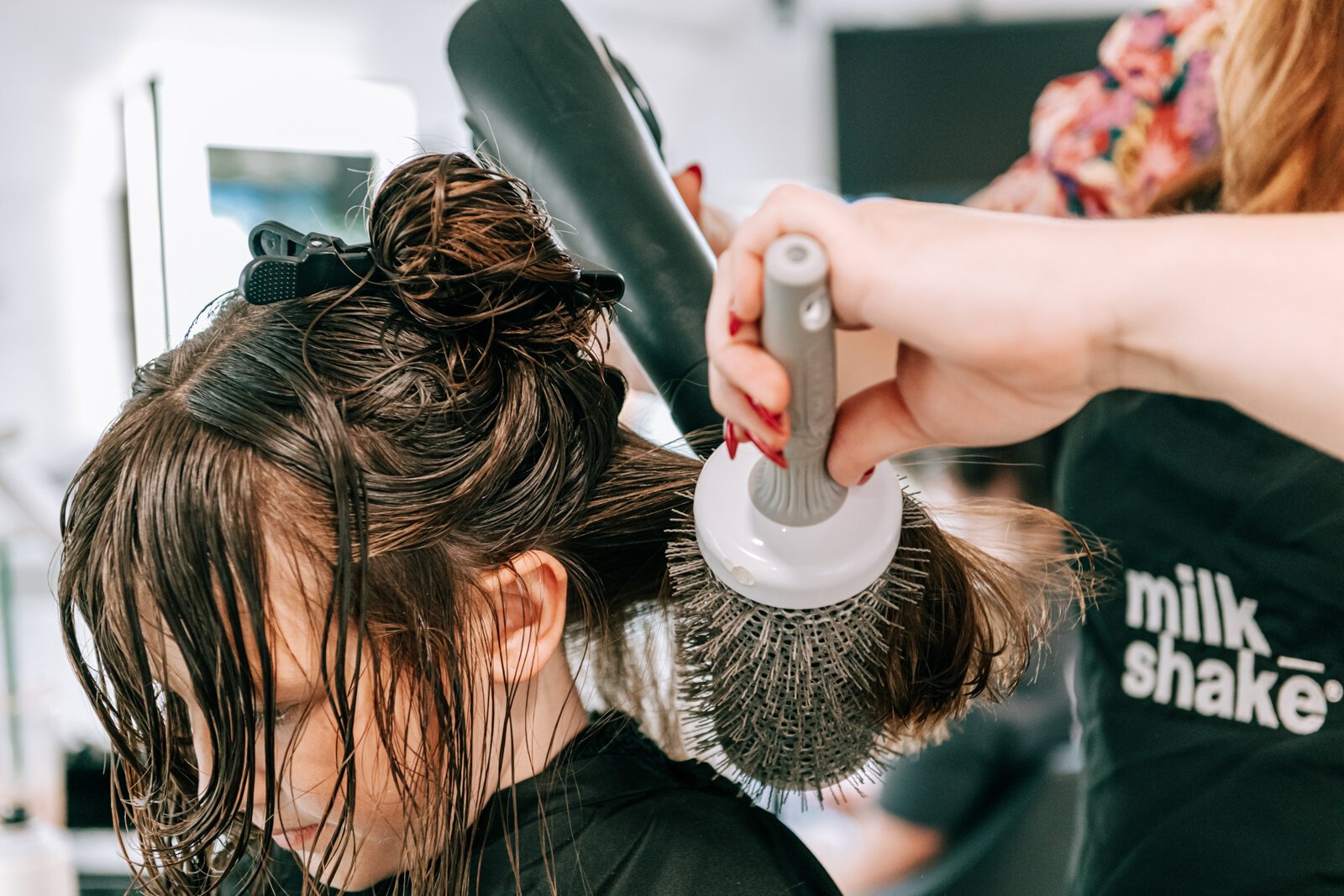 Owner Beth Morken works on giving Avyn Oliver, 10, a kid's cut, blow dry and style on the 260HairBus.