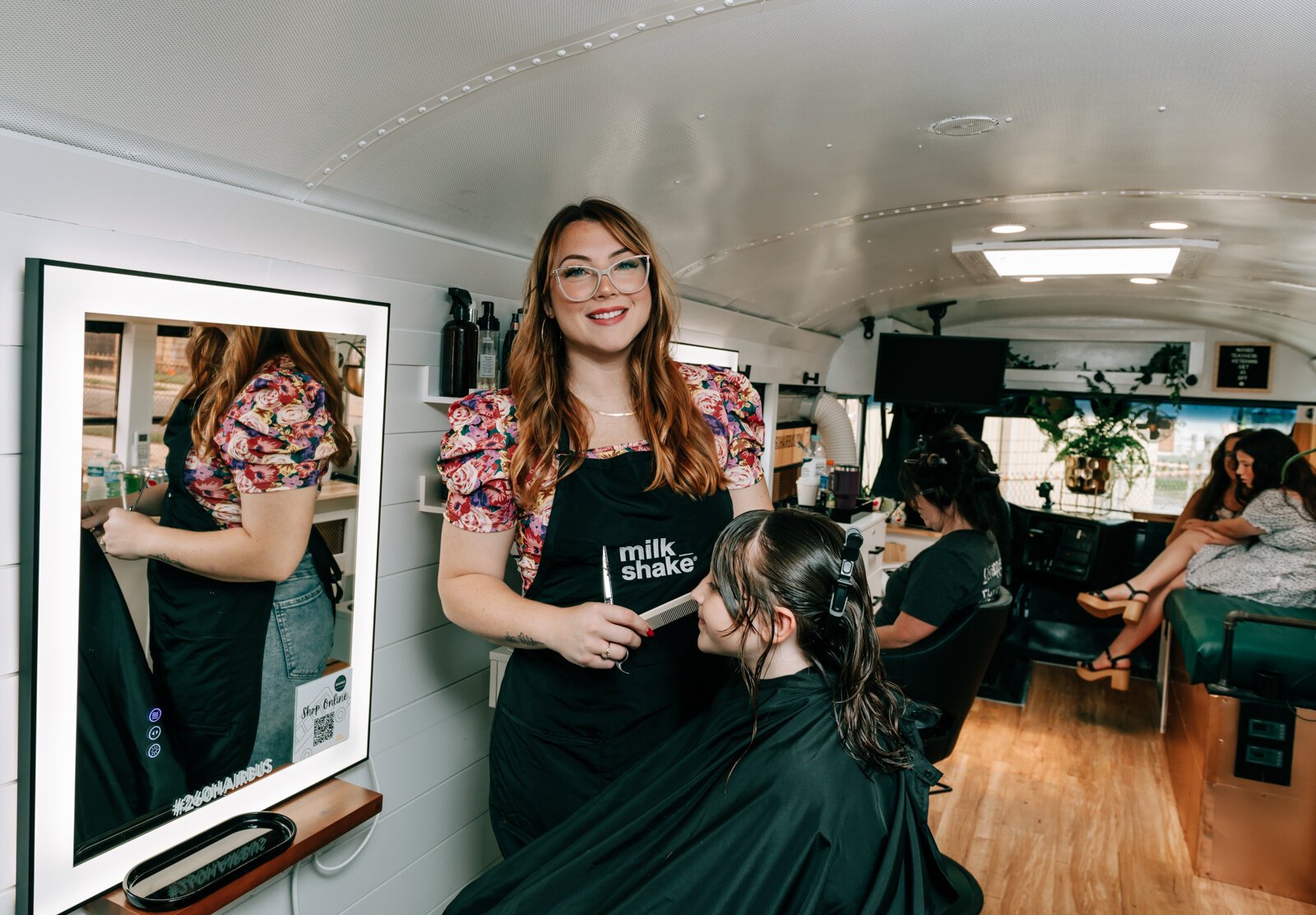 Owner Beth Morken works on giving Avyn Oliver, 10, a kid's cut, blow dry and style on the 260HairBus.