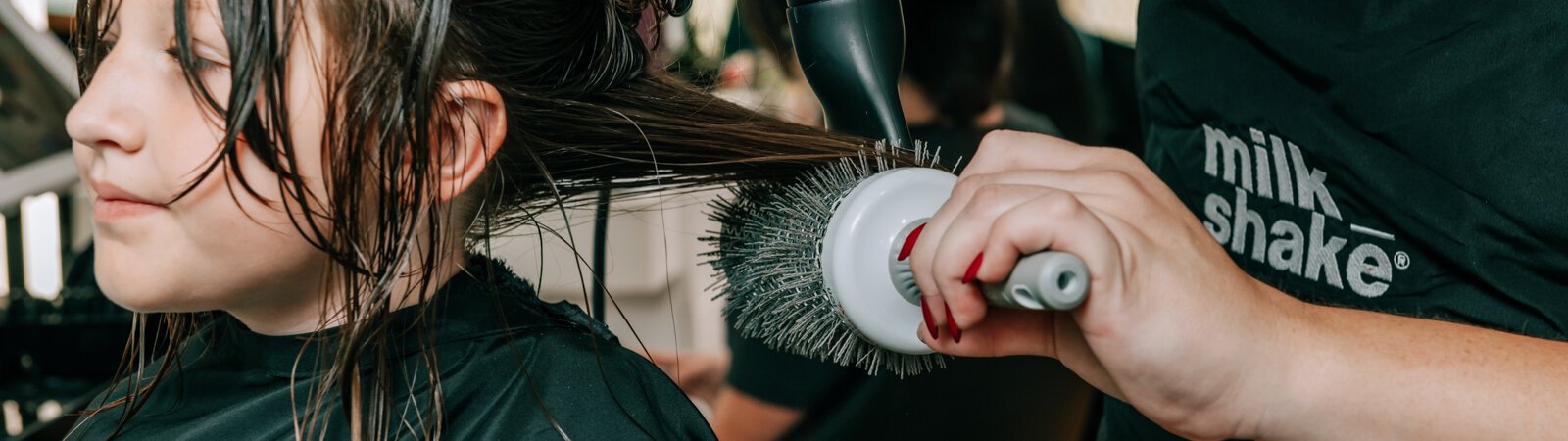 Owner Beth Morken works on giving Avyn Oliver, 10, a kid's cut, blow dry and style on the 260HairBus.