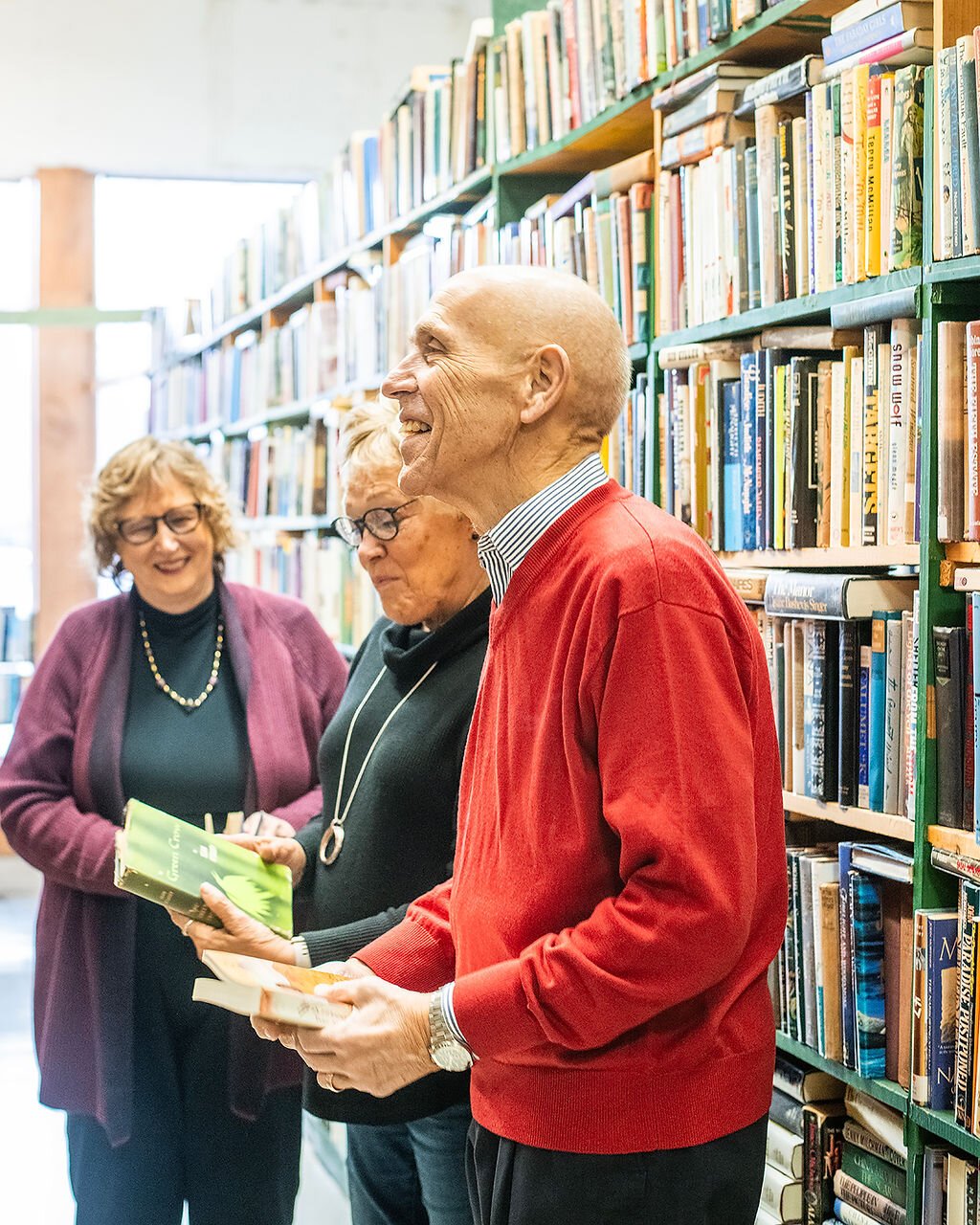 Retirees (left to right) Jan Roland, Beverly Vanderpool, and Dave Haist browse books at Reading Room Books in Wabash.