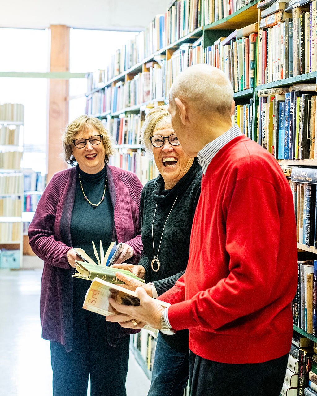 Retirees (left to right) Jan Roland, Beverly Vanderpool, and Dave Haist browse books at Reading Room Books in Wabash.