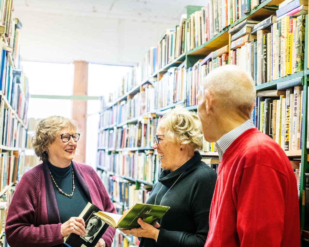 Retirees (left to right) Jan Roland, Beverly Vanderpool, and Dave Haist browse books at Reading Room Books in Wabash.