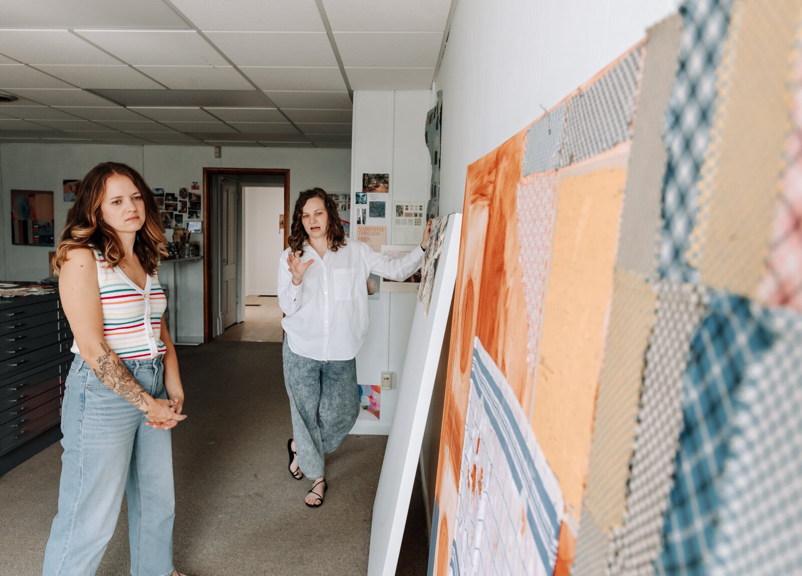 Dana Caldera, right, talks about her work with Kaylan Buteyn in their studio space at Kinhouse Gallery.