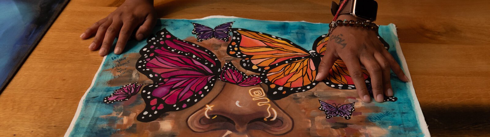 Artist BonJo points out details in her self portrait.
