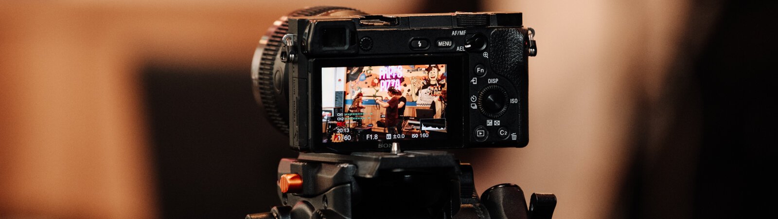 A camera filming during the Creator Space 1 Year Bash at Papi's Pizza on The Landing in Fort Wayne, IN.