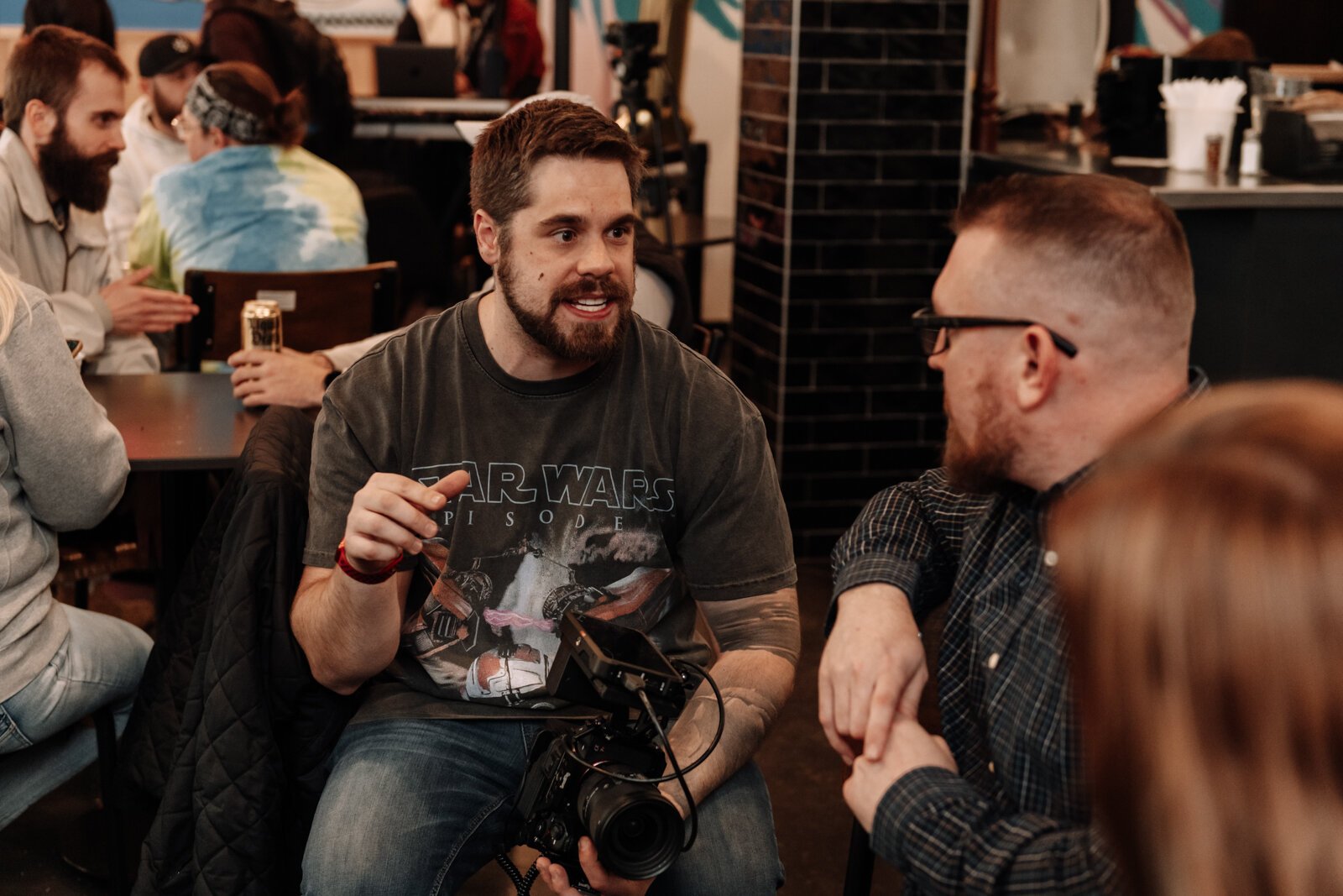 Creator Space Founder Zach Vessels talks with guests during the Creator Space 1 Year Bash.