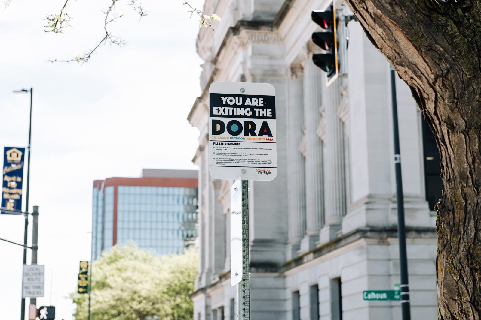 A sign at Main Street and Calhoun Street reminds people of the rules within the new Downtown DORA (Designated Outdoor Refreshment Area).