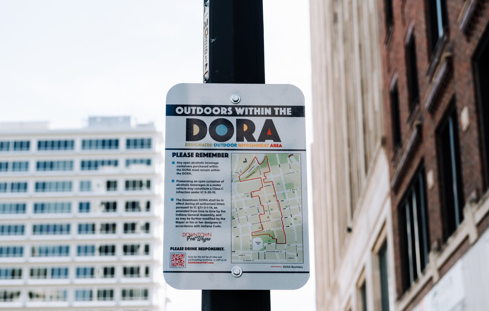 A sign at Berry Street and Calhoun Street reminds people of the rules within the new Downtown DORA (Designated Outdoor Refreshment Area).