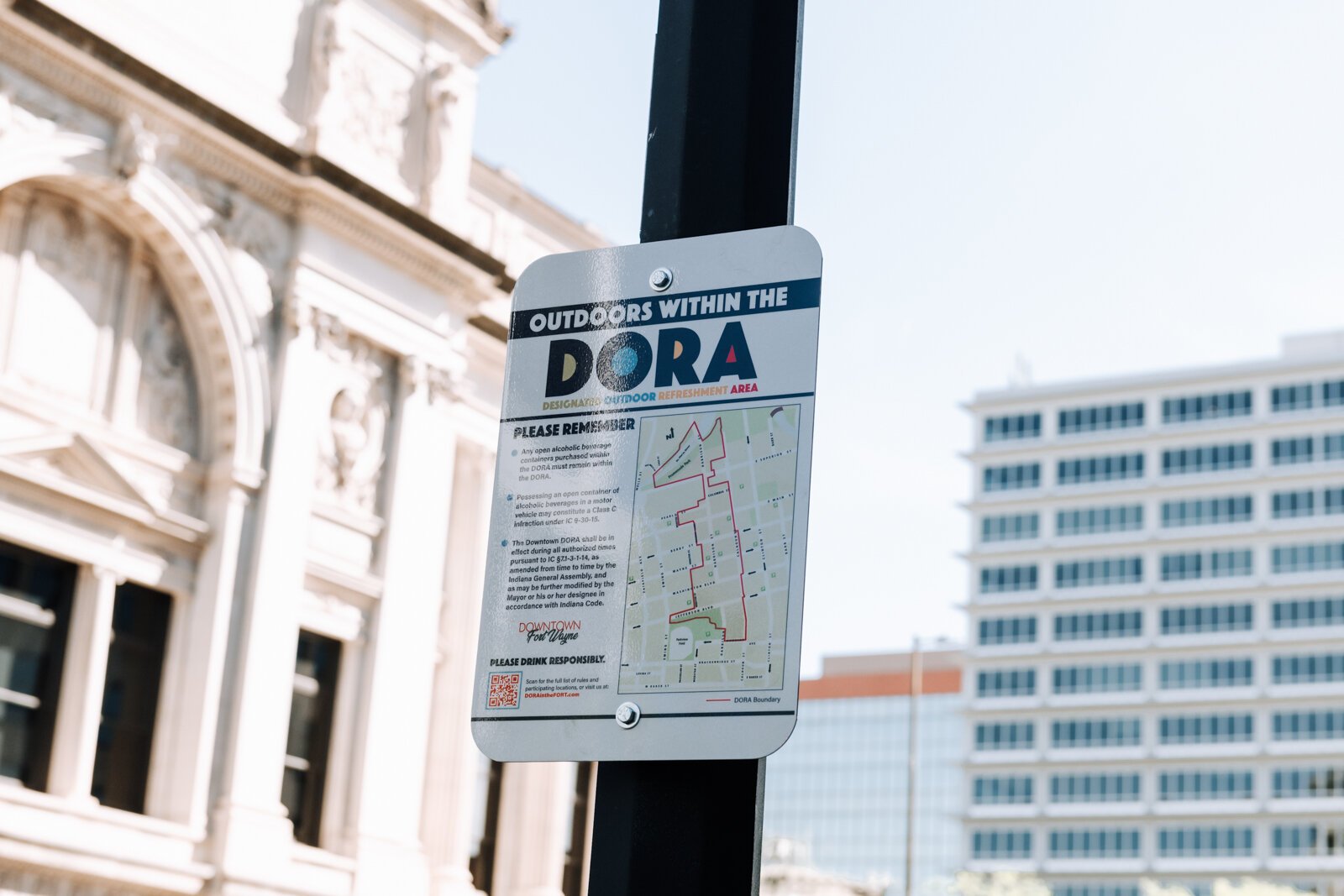 A sign at Berry Street and Calhoun Street reminds people of the rules within the new Downtown DORA (Designated Outdoor Refreshment Area).