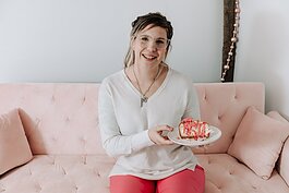 Owner and founder Grayce Holloway holds the frosted animal cookie cheesecake at Icing for Izaac, 243 Airport North Office Park, Fort Wayne, IN 46825.