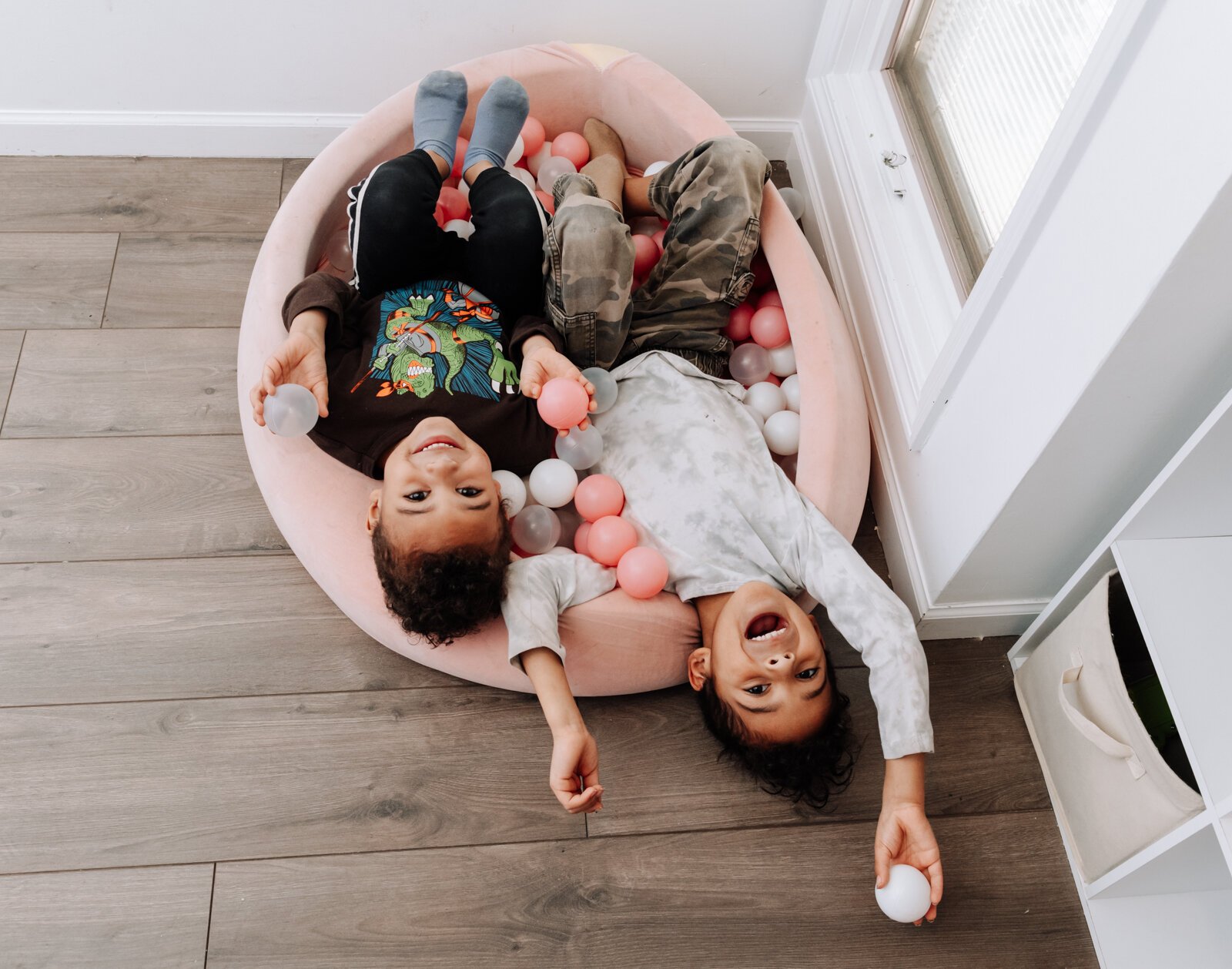 Zaden, 5, left, and Eizajah, 6, enjoy the ball pit in the children's playroom at Icing for Izaac.