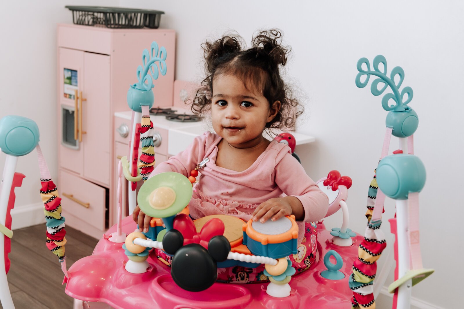 Mia, 1.5, enjoys a bouncer in the children's playroom at Icing for Izaac.