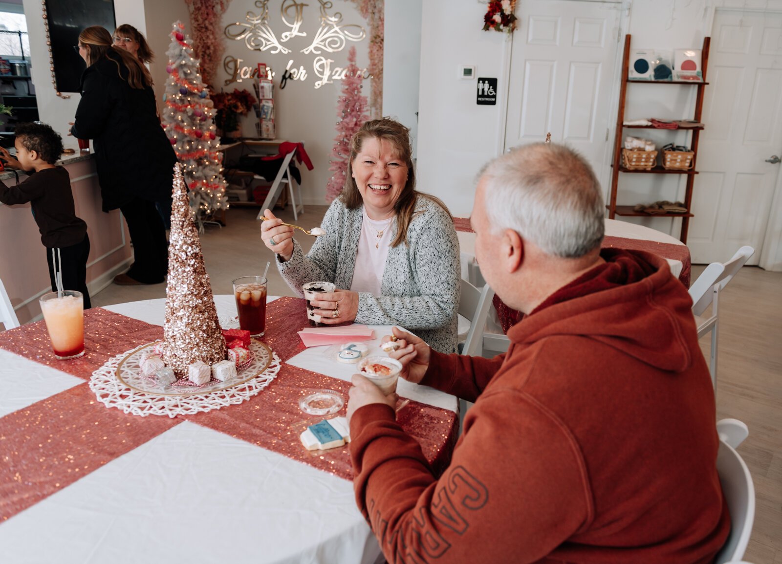 Regular customers Natalie, left, and Jason Bohde enjoy cheesecake cups at Icing for Izaac.