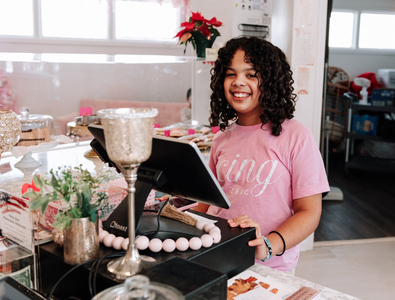 Makenzie, 11, works the counter of her mother's bakery cafe, Icing for Izaac.