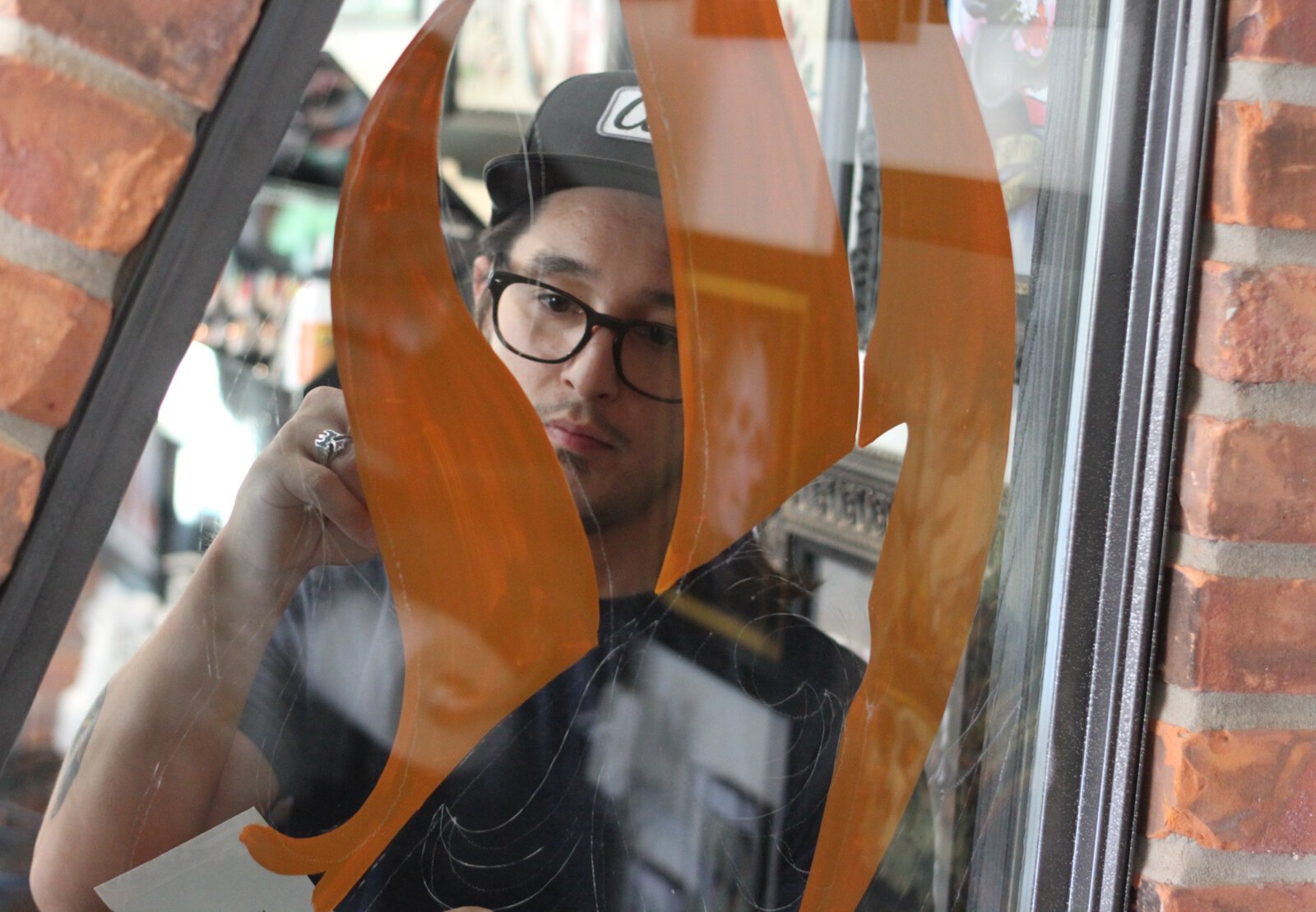 Sign painter Justin Lim works on painting at Studio 13 at their Toledo location.