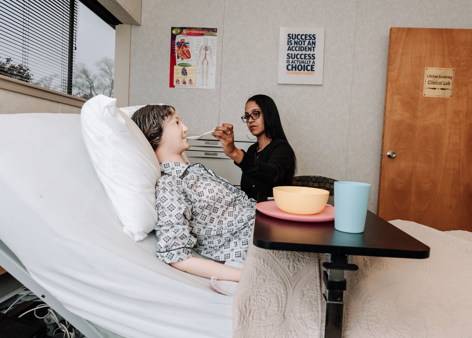 Student Mollie Niles practices an assist to feed while at Lifeline Academy.