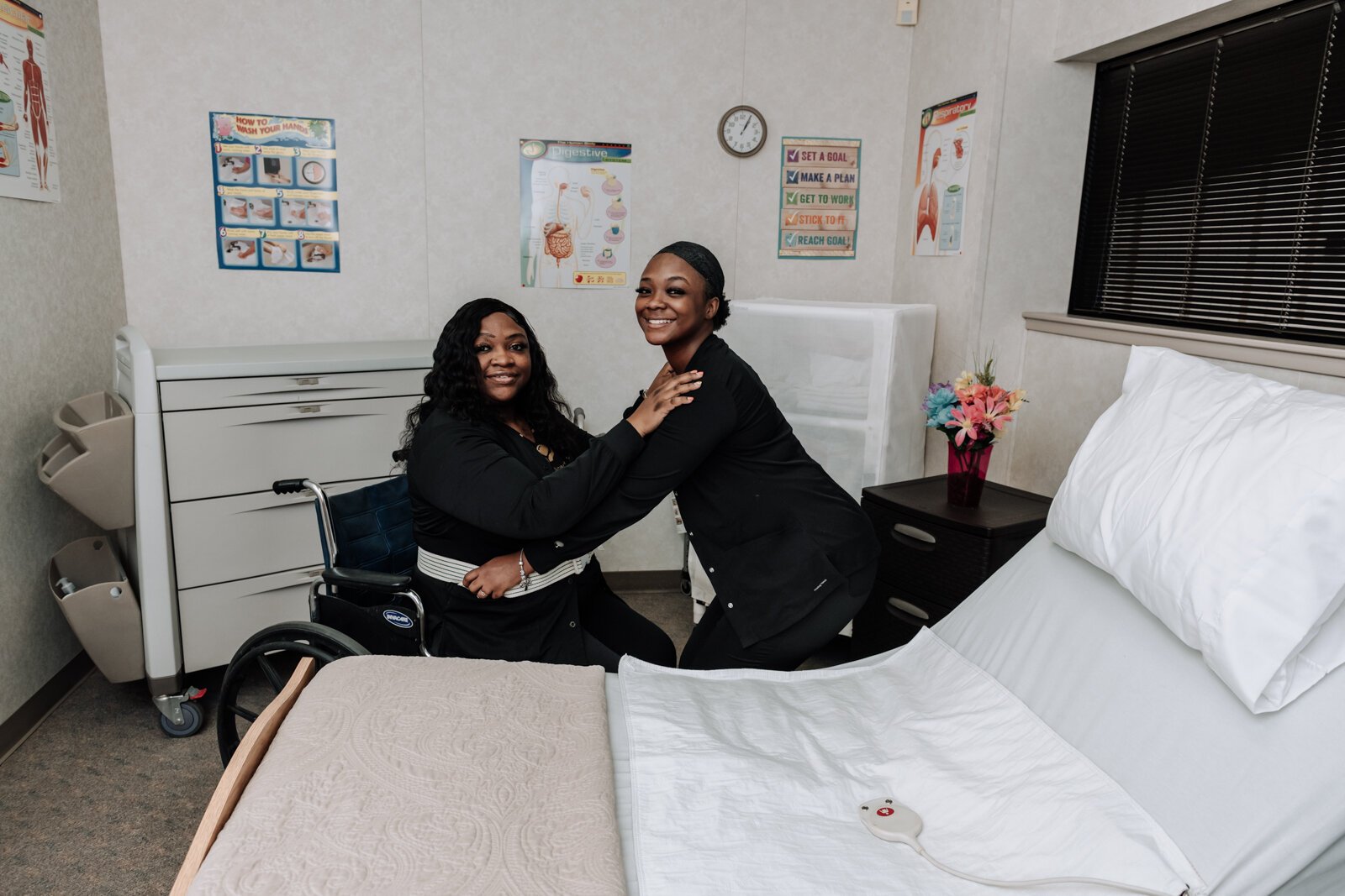 Student Ja'Lona Franklin, helps mother SeAndra Robinson RN CEO with a wheelchair assist while at Lifeline Academy.