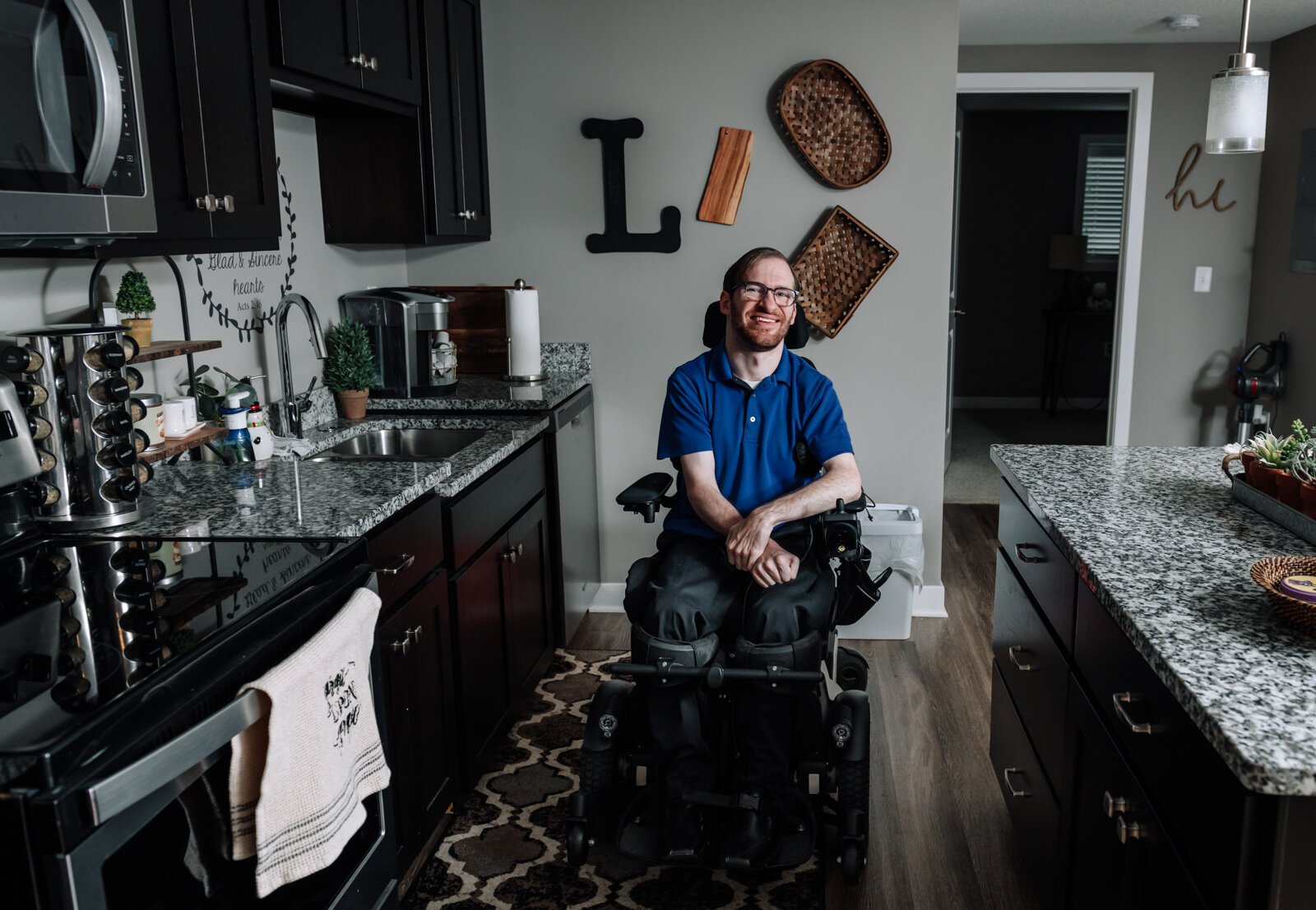 Luke Labas shows off how much space he has in the kitchen of his apartment in Fort Wayne, IN.