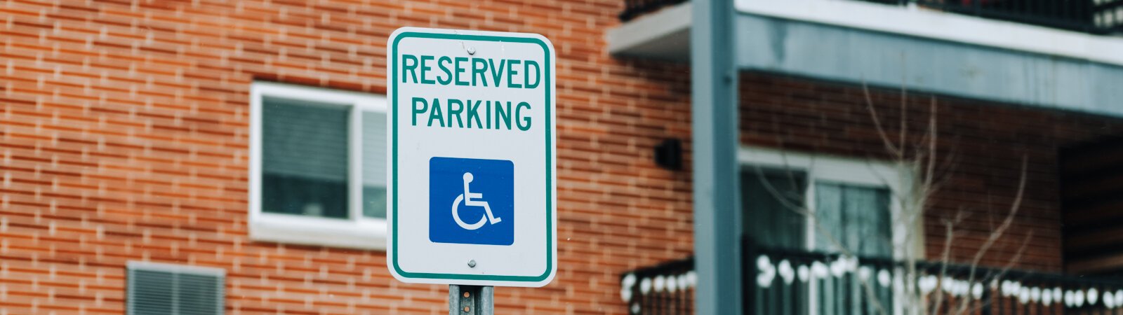A handicapped parking sign outside of an apartment complex in Fort Wayne, IN.