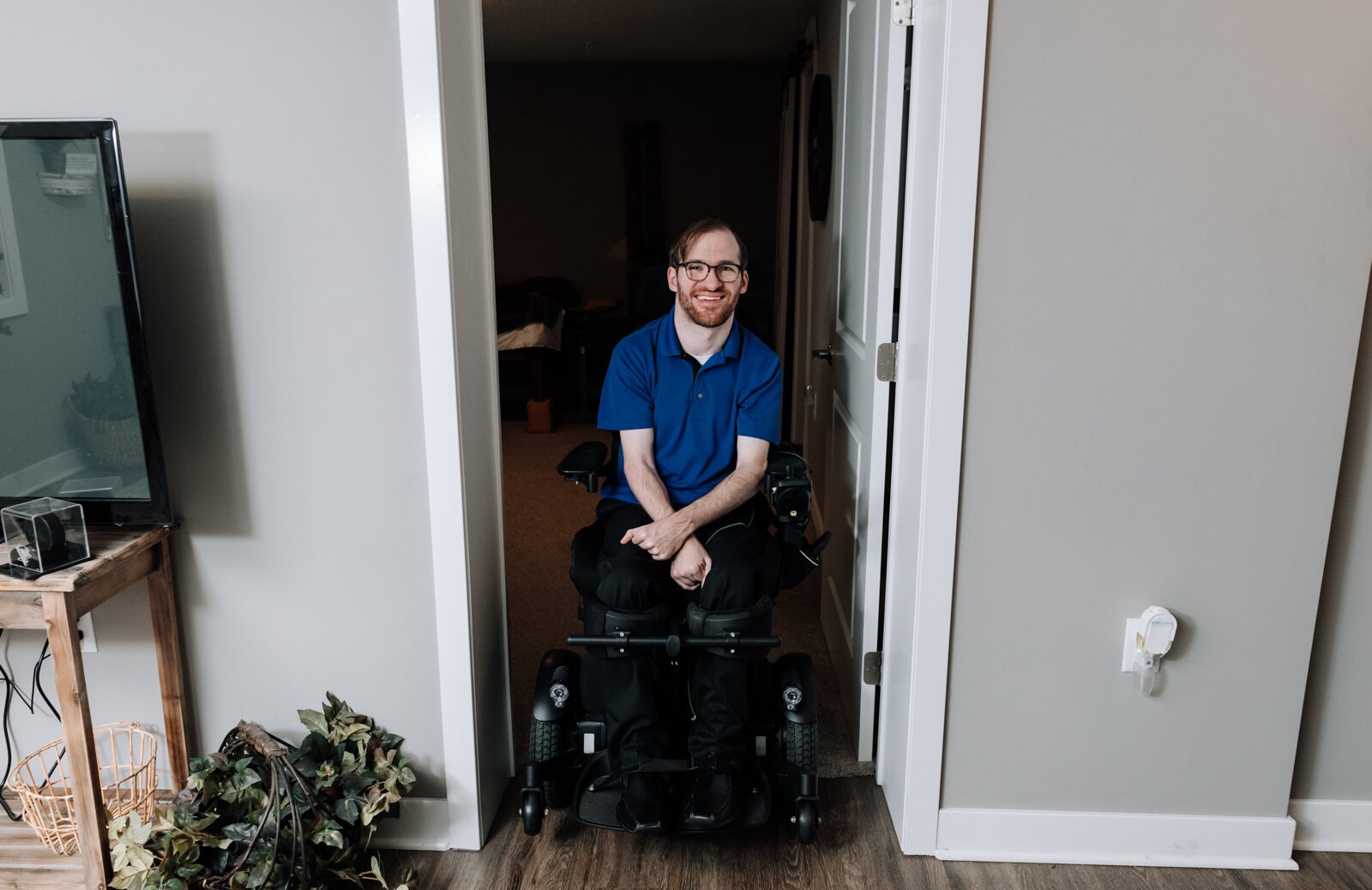 Luke Labas shows the width of the bedroom doorway in his apartment in Fort Wayne, IN.