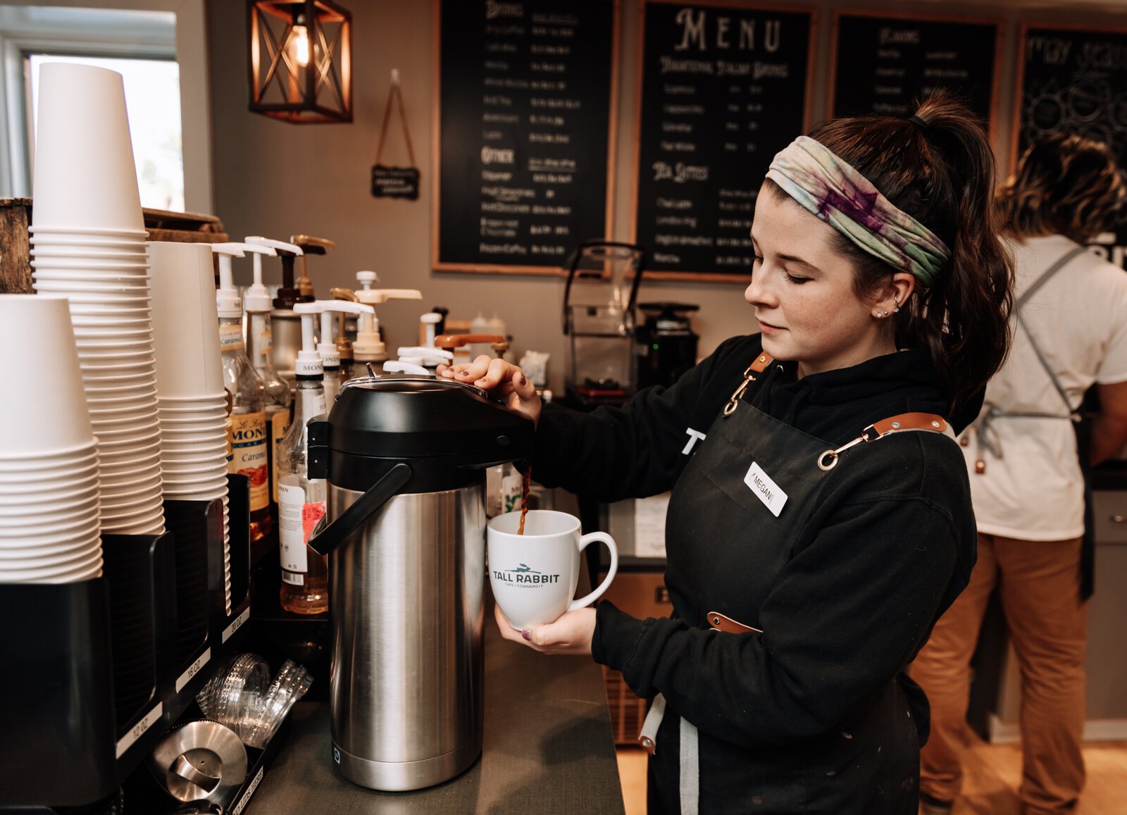 Megan Spring, cafe manager, pours a cup of coffee at Tall Rabbit.