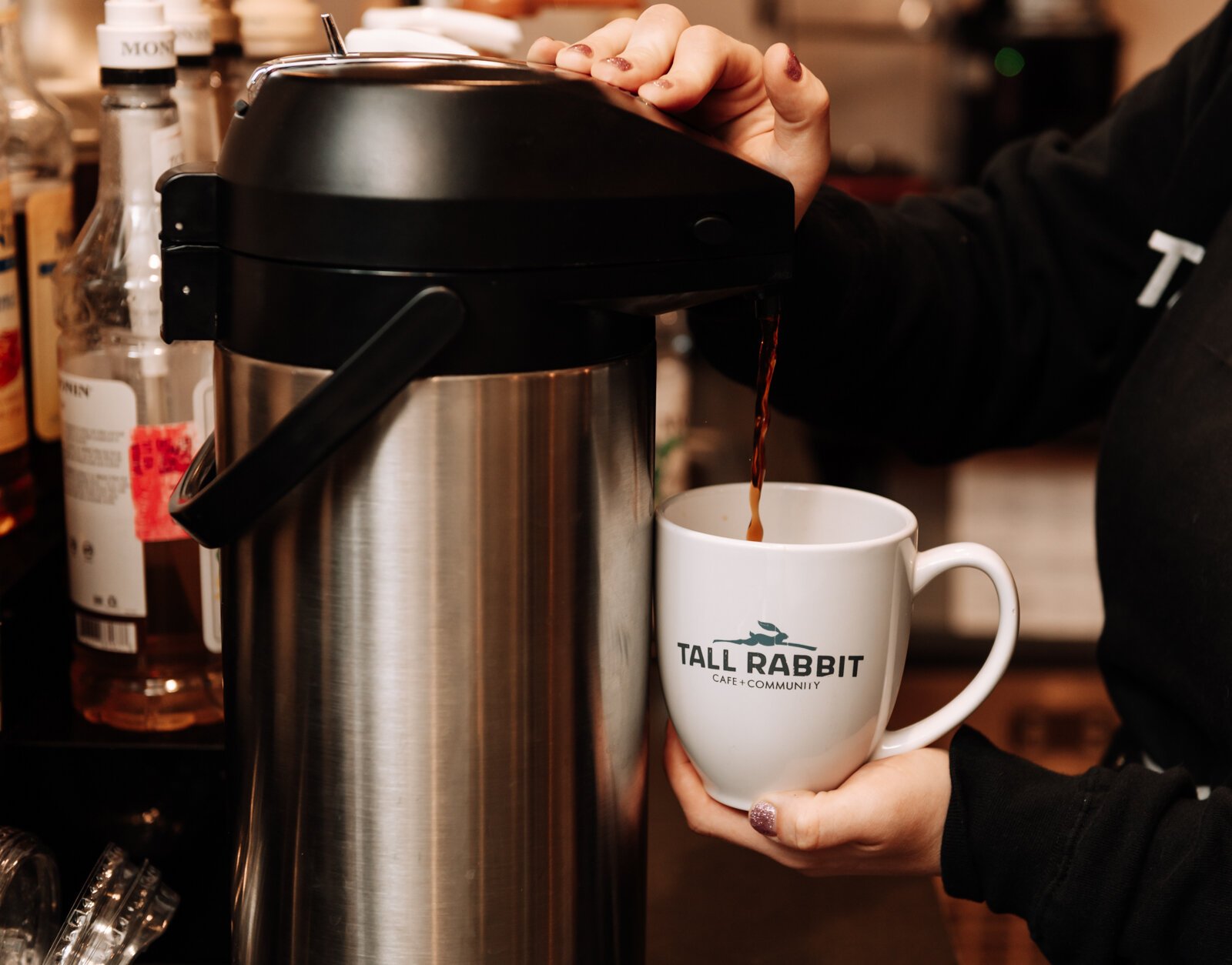 Megan Spring, cafe manager, pours a cup of coffee at Tall Rabbit.