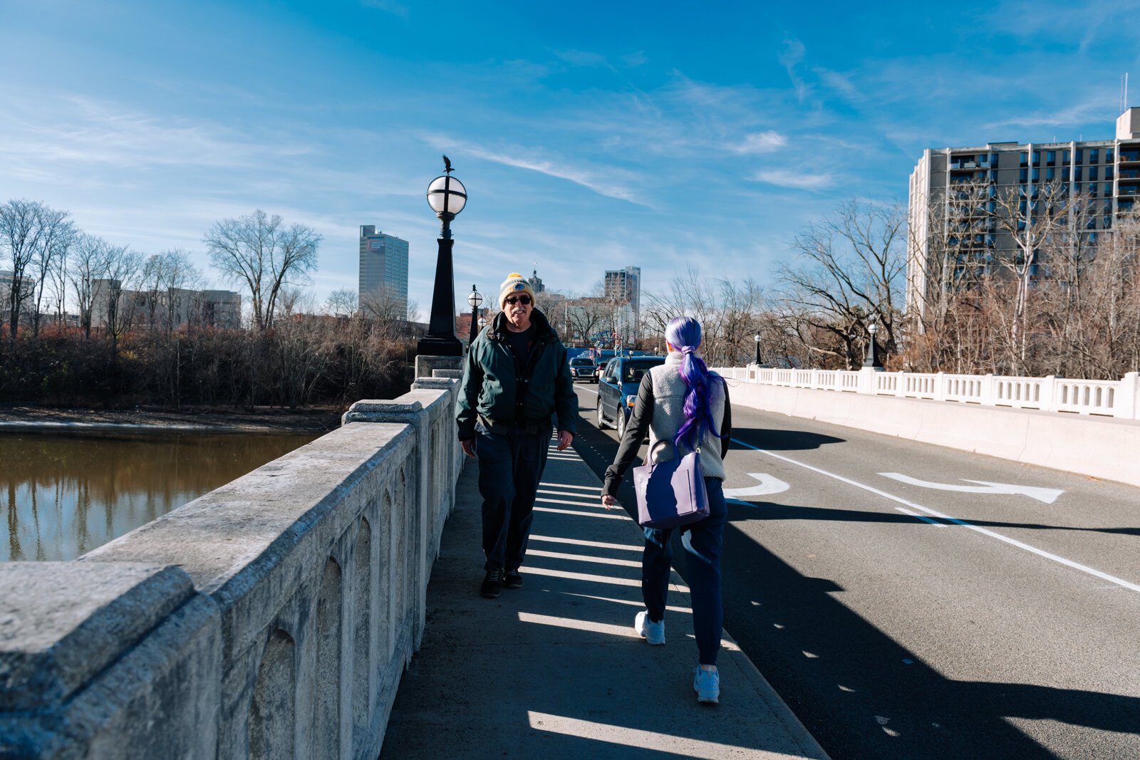 Mike Roeger and Rachel Jones pass each other on the bridge on Saint Joe Boulevard, showcasing how small the sidewalk is.