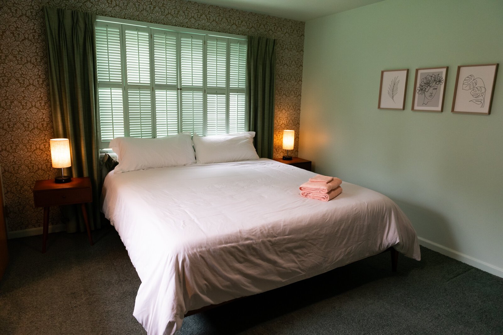 One of the bedrooms features green accents and art.