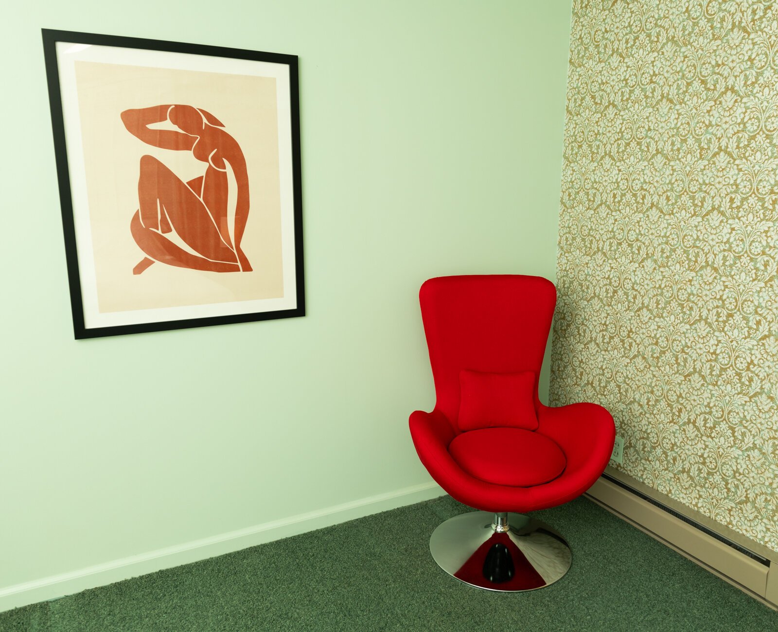 One of the bedrooms features green accents and art.