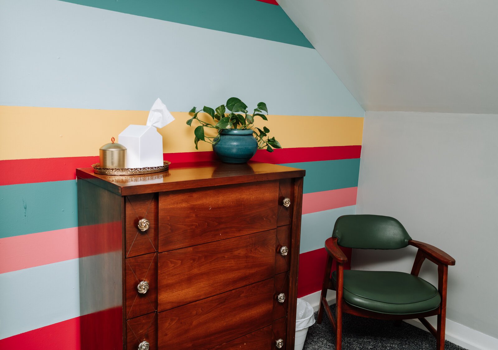 A colorful mural behind the dresser in one of the guest bedrooms.