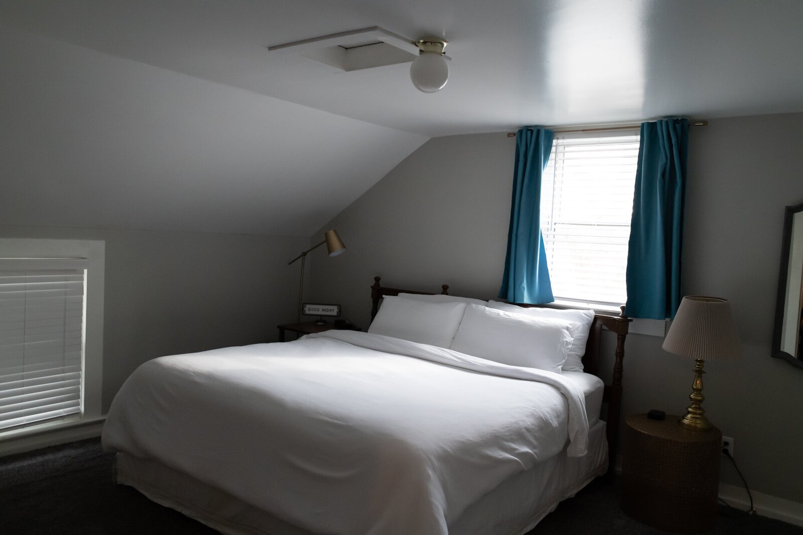 This cozy bedroom features a king size bed and light decor.