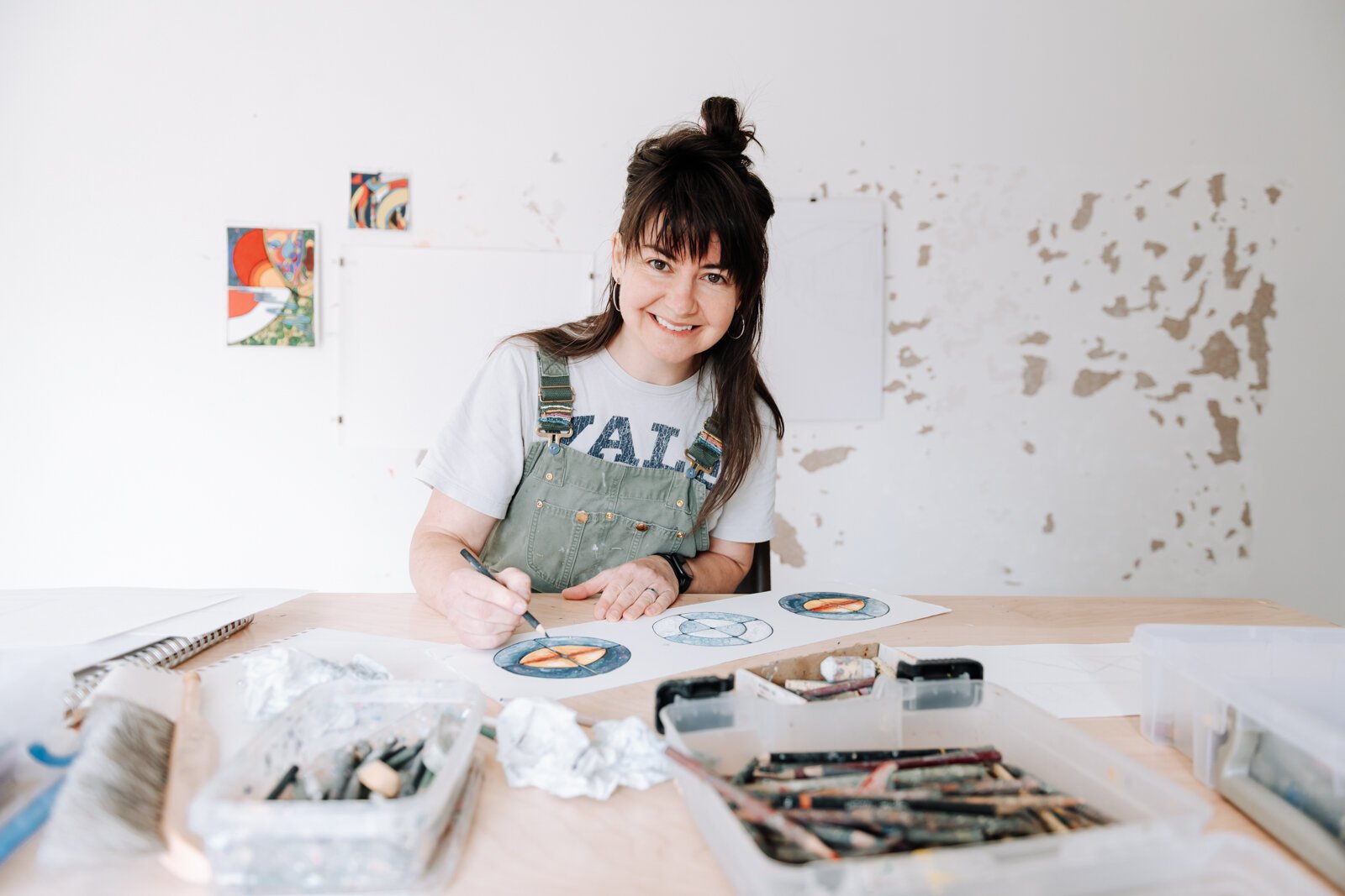 Sarah Wolfe, artist in residence, works on an exquisite corpse collaboration piece while at 930 Illsley Dr, Fort Wayne, IN on May 8, 2025.