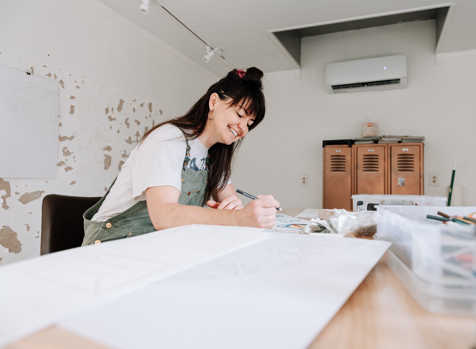 Sarah Wolfe, artist in residence, works on an exquisite corpse collaboration piece while at 930 Illsley Dr, Fort Wayne, IN on May 8, 2025.