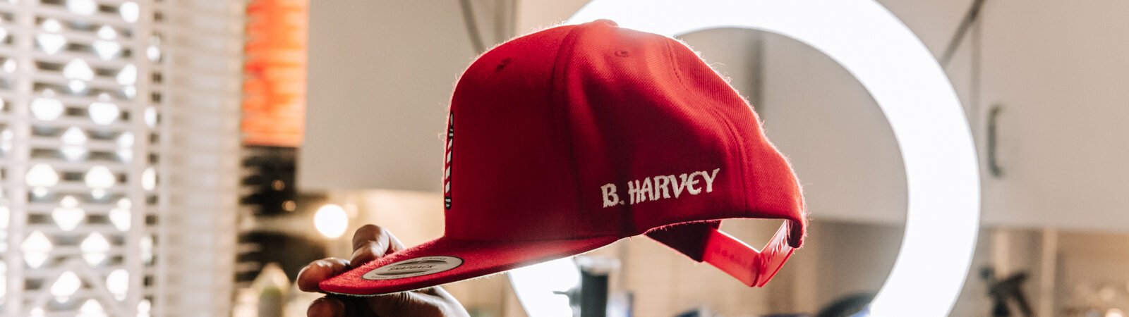 Local barber Benson Harvey, owner of Smooth Kutz, LLC, holds up his hat.