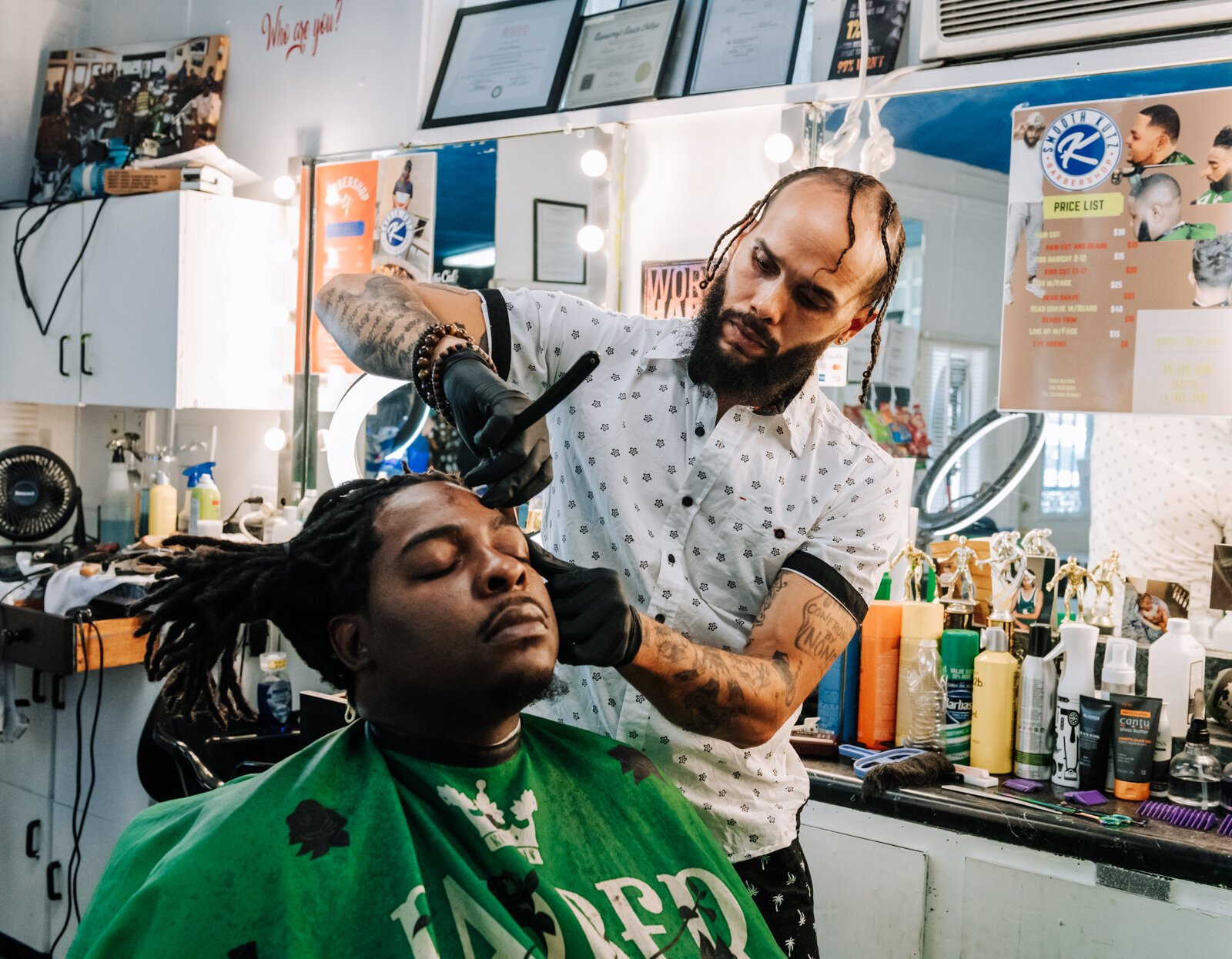 Greg Bolden works on giving a customer a line up at at Smooth Kutz.