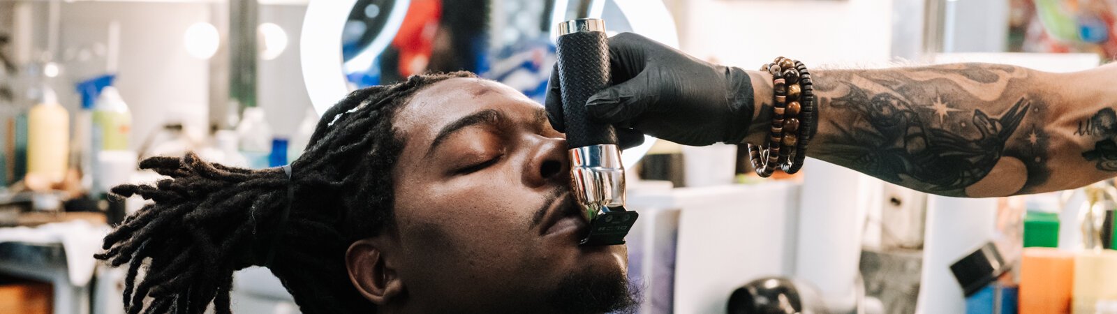 Greg Bolden works on giving a customer a line up at at Smooth Kutz Barbershop.