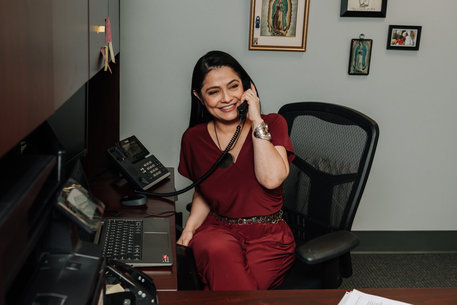 Luz Ostrognai with Catholic Charities works in her office at the Archbishop Noll Catholic Center.